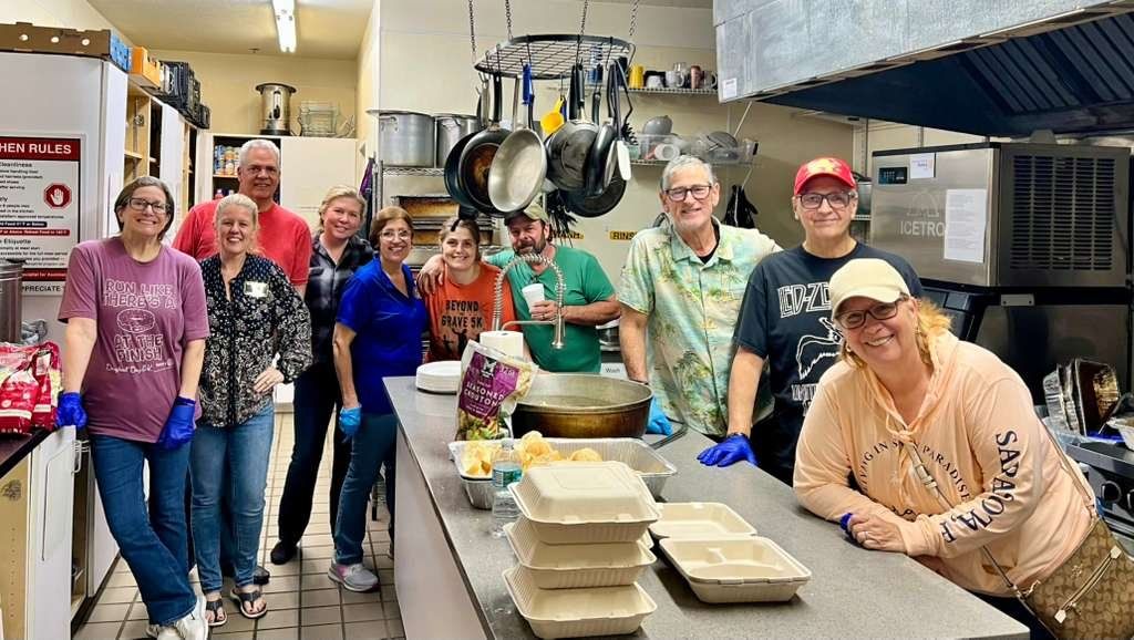The kitchen crew with dinners boxed and ready to serve
